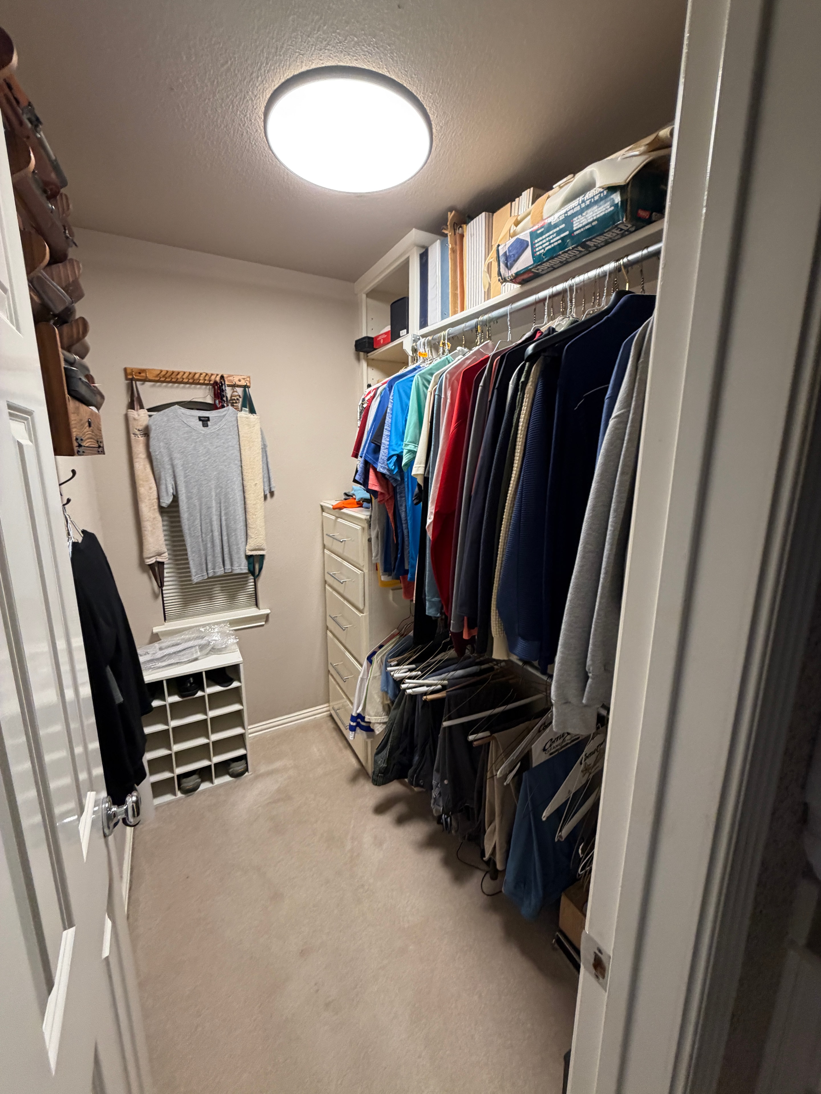 Cluttered storage closet with shelves full of miscellaneous items